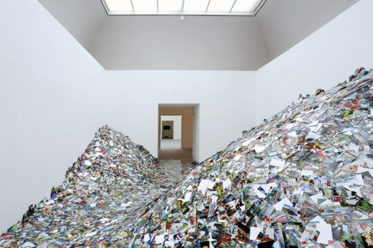 a room filled with photographs piled high