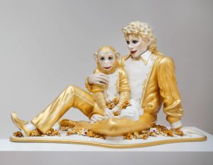 A large gold and white sculpture of Michael Jackson and his pet monkey, Bubbles.