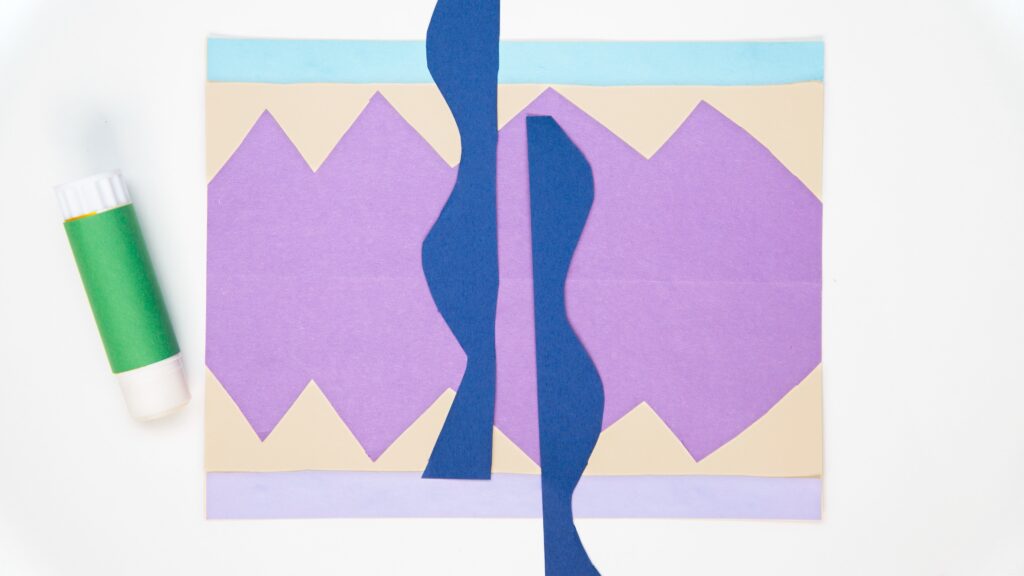 Still from a video project inspired by artist Georgia O'Keeffe that shows various blue, purple, and beige paper cutouts to make a landscape.