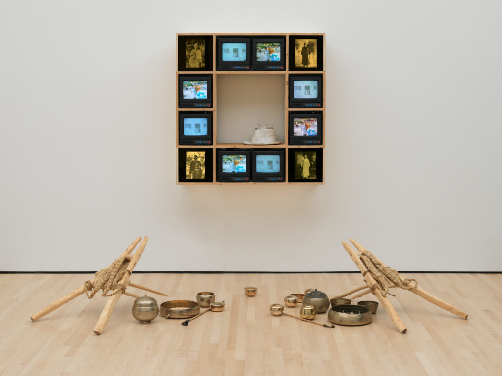 Nam June Paik's Chongo Cross, featuring 9 tv screens along with copper and metal instruments.
