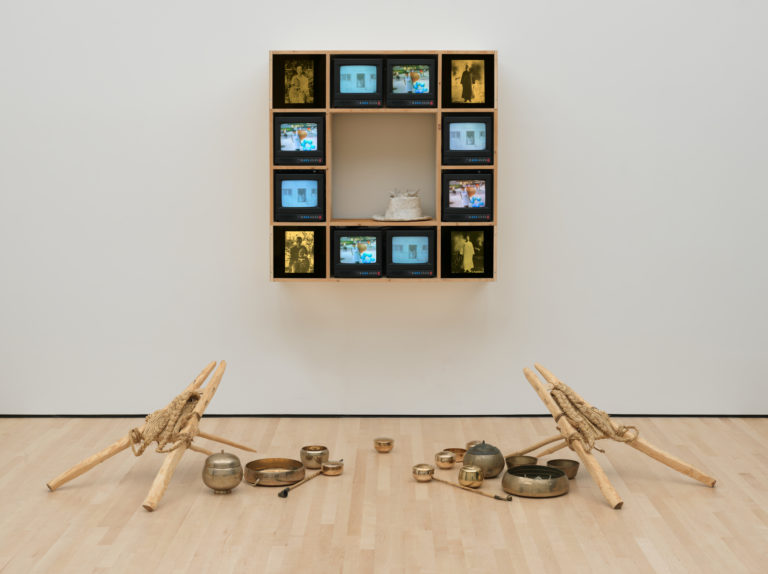 Nam June Paik's Chongo Cross, featuring 9 tv screens along with copper and metal instruments.