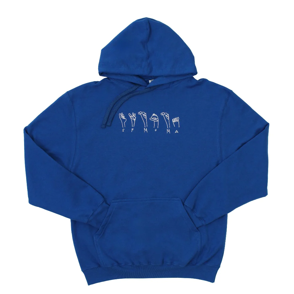 A picture of a blue hooded sweatshirt which says SFMOMA on the front in both text and ASL.